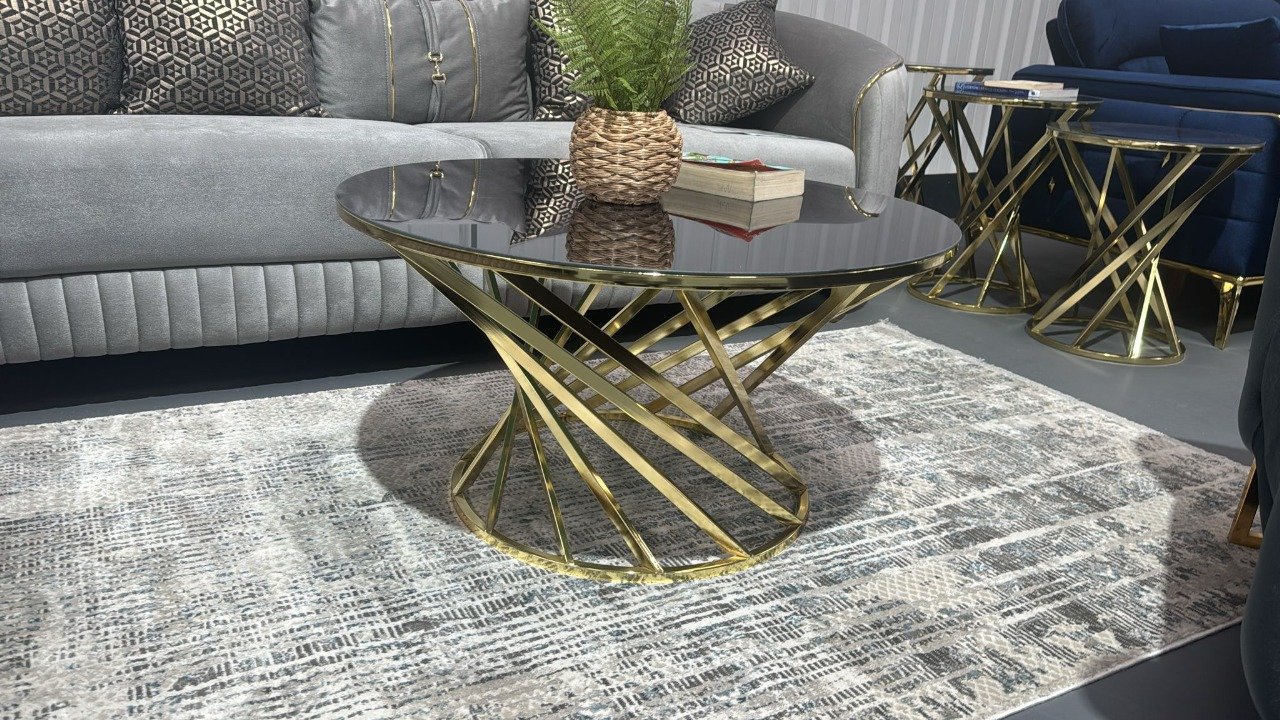 Modern living room with Branson Coffee Table featuring a circular black glass top and gold base.