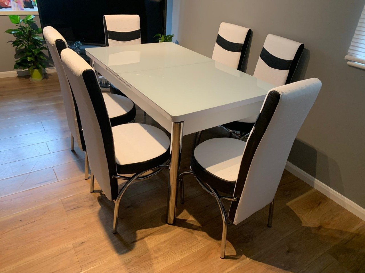 ClearSpan Dining Set with a white table and six white and black chairs.