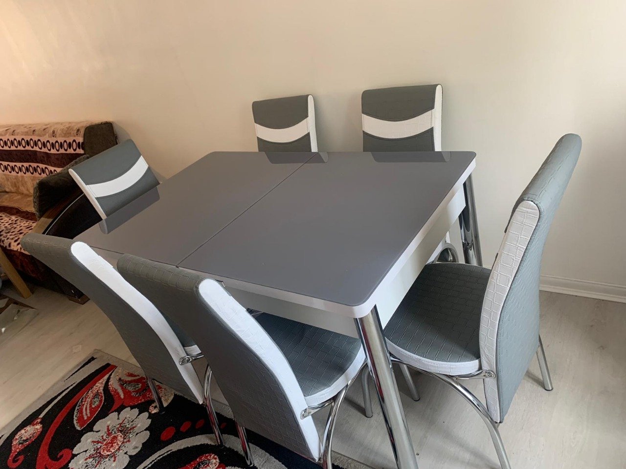 ClearSpan Dining Set with a gray table and six matching gray and white chairs in a modern dining room.