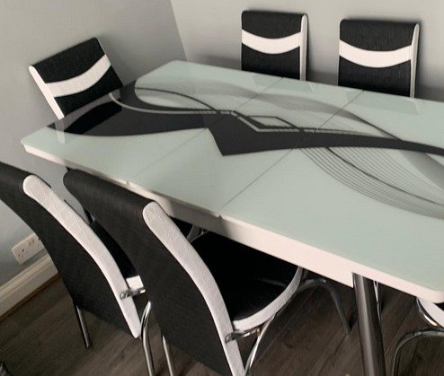 ReflectaTone Dining Set with a glass table and six chairs featuring black and white design elements.