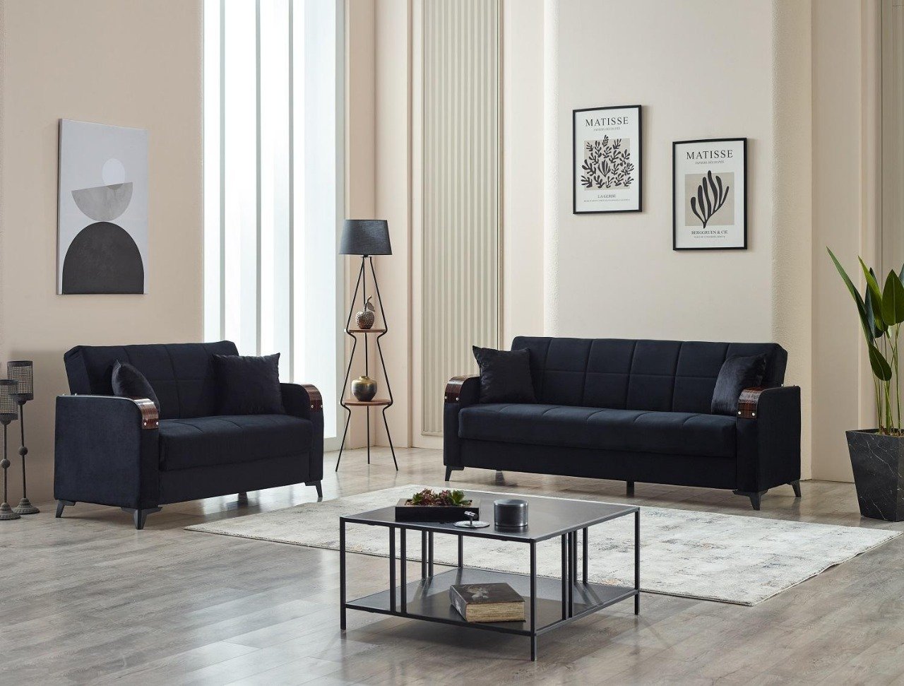 Modern living room with dark blue sofas, minimalist decor, and framed artwork.
