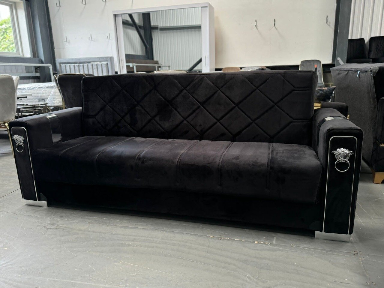 Velora Black Sofa Bed with diamond-patterned tufting and silver embellishments.