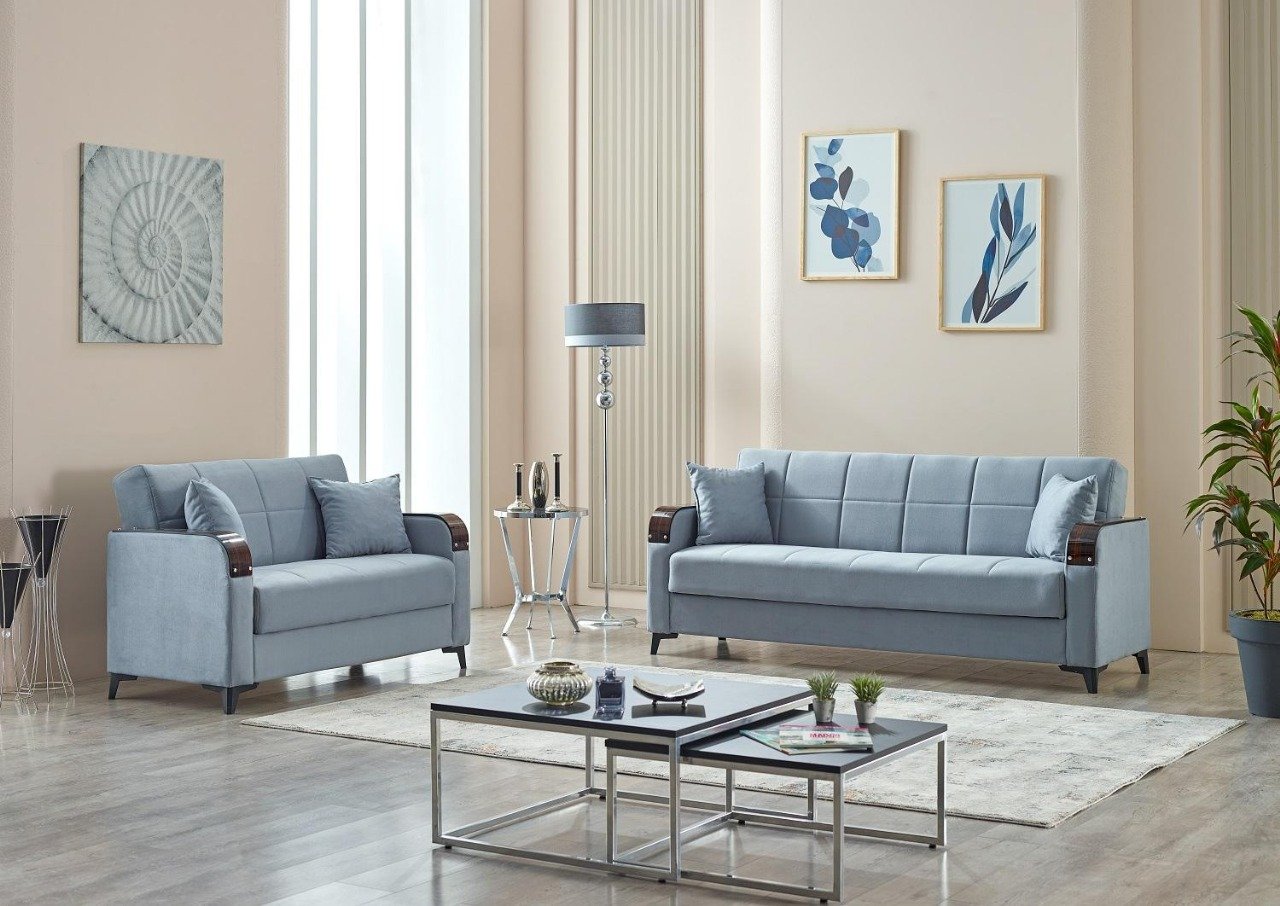 Modern living room with grey sofas, minimalist decor, and framed artwork.