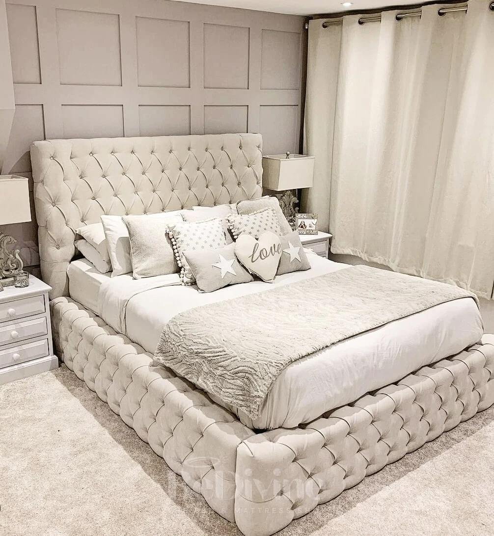 Luxurious bedroom with tufted queen size bed, decorative pillows, and matching nightstands.